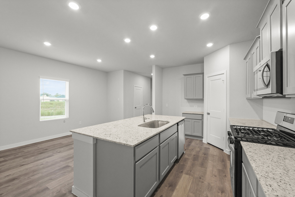 A kitchen with white cabinets.
