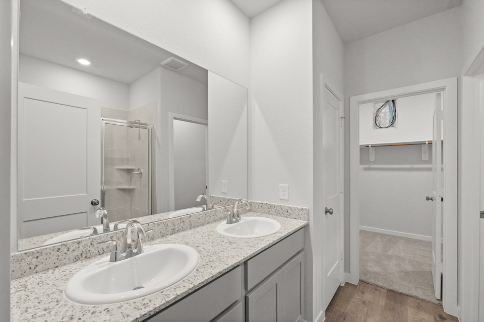 A bathroom with a large mirror.