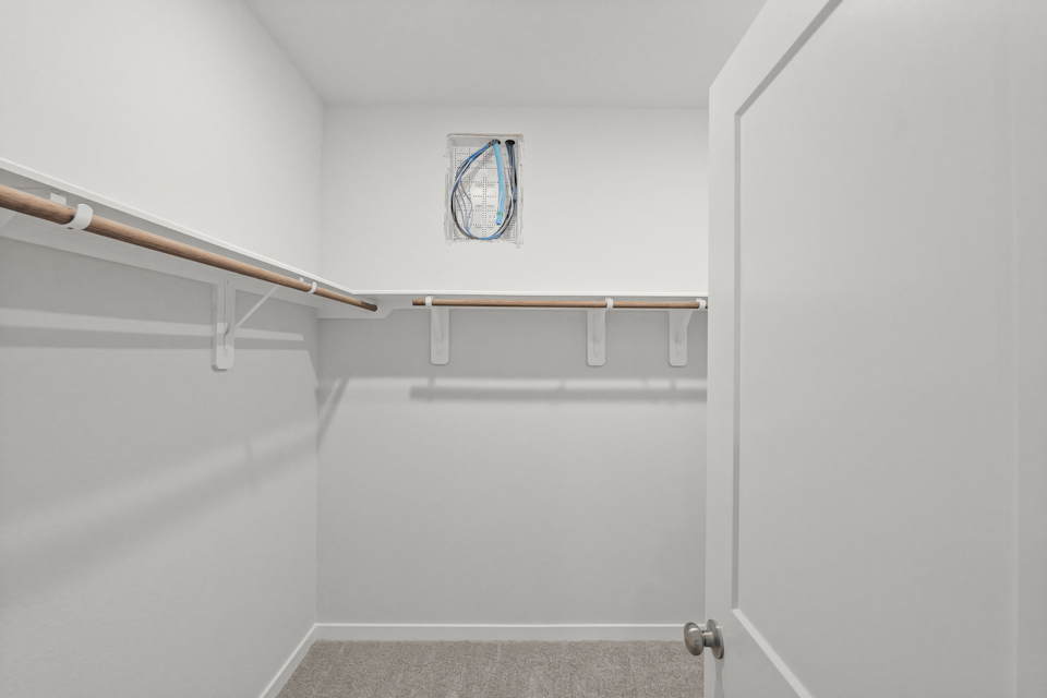 A white door with a metal bar.