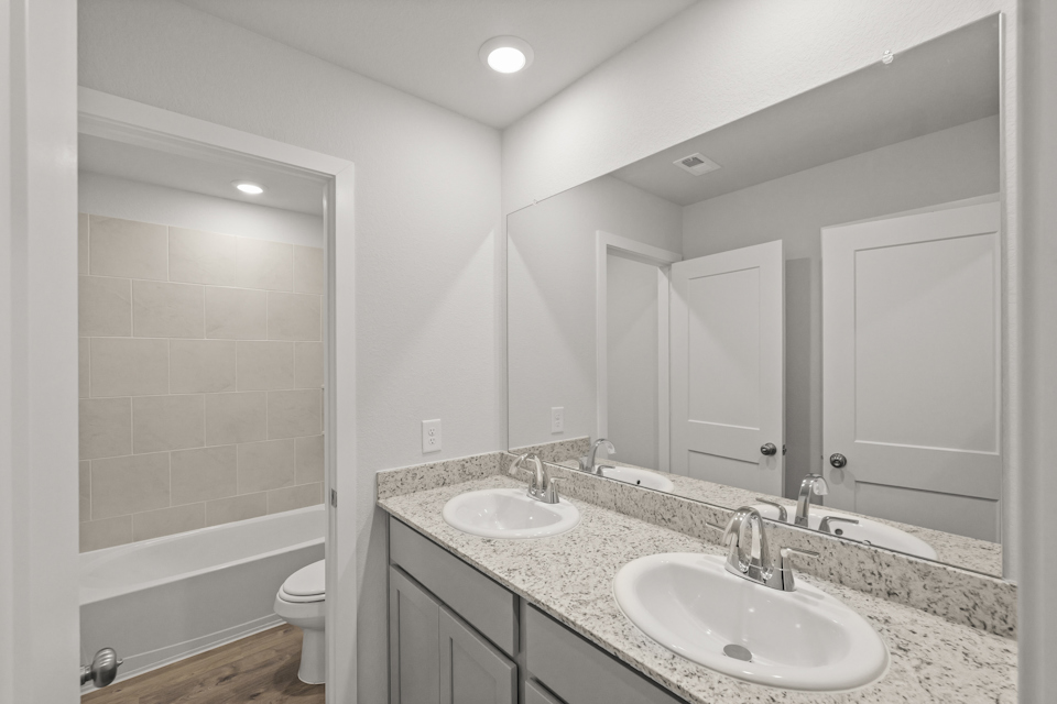 A bathroom with a large mirror.