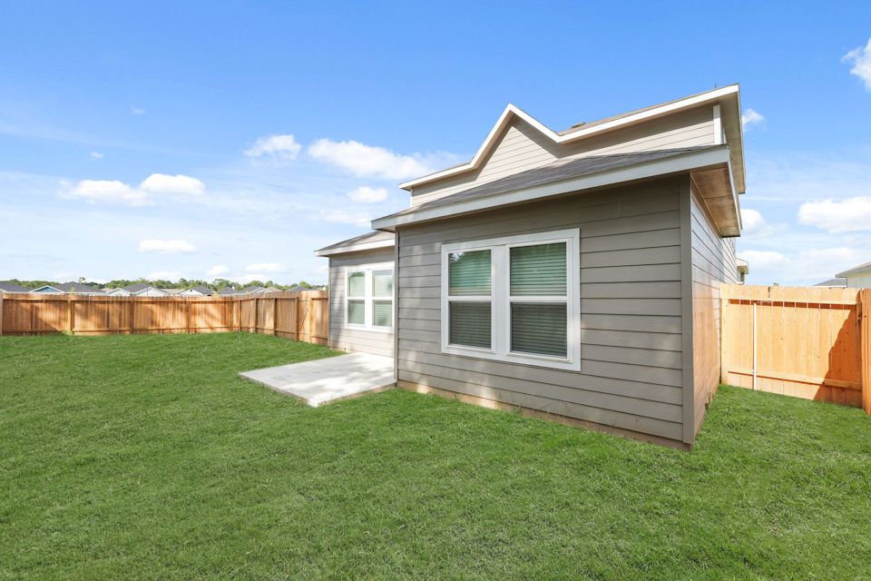 A small house in a grassy yard.