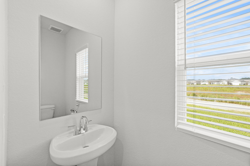 A bathroom with a sink and a mirror.