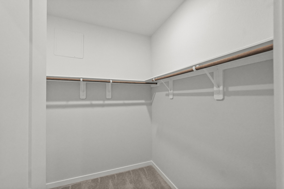A white wall with a metal railing.
