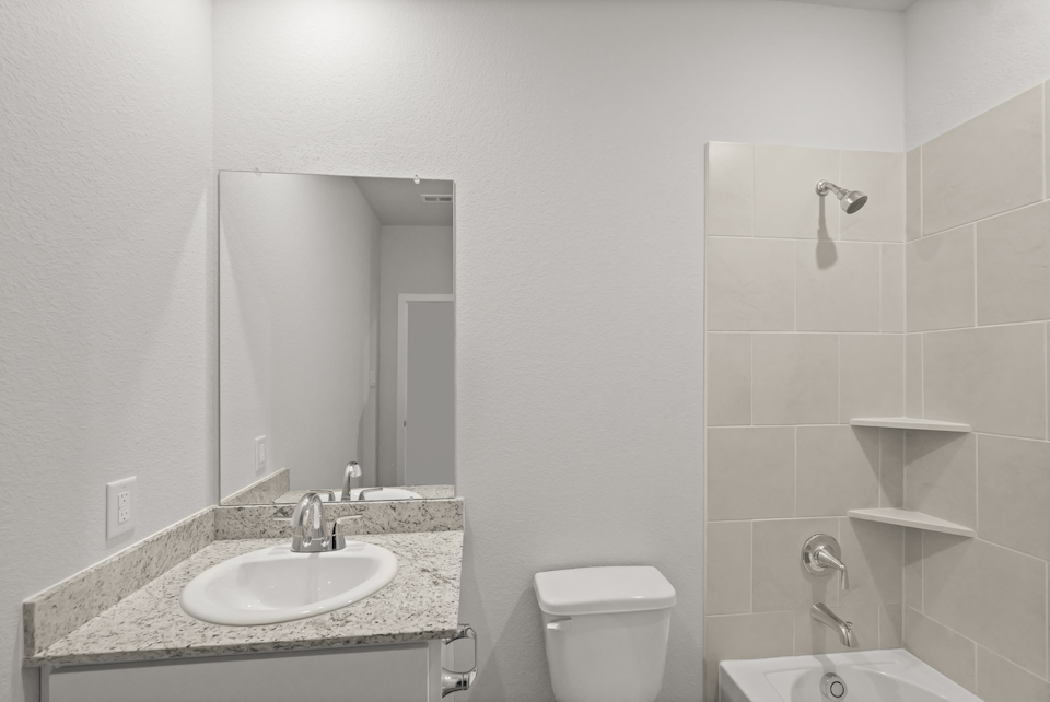 A bathroom with a sink and a mirror.