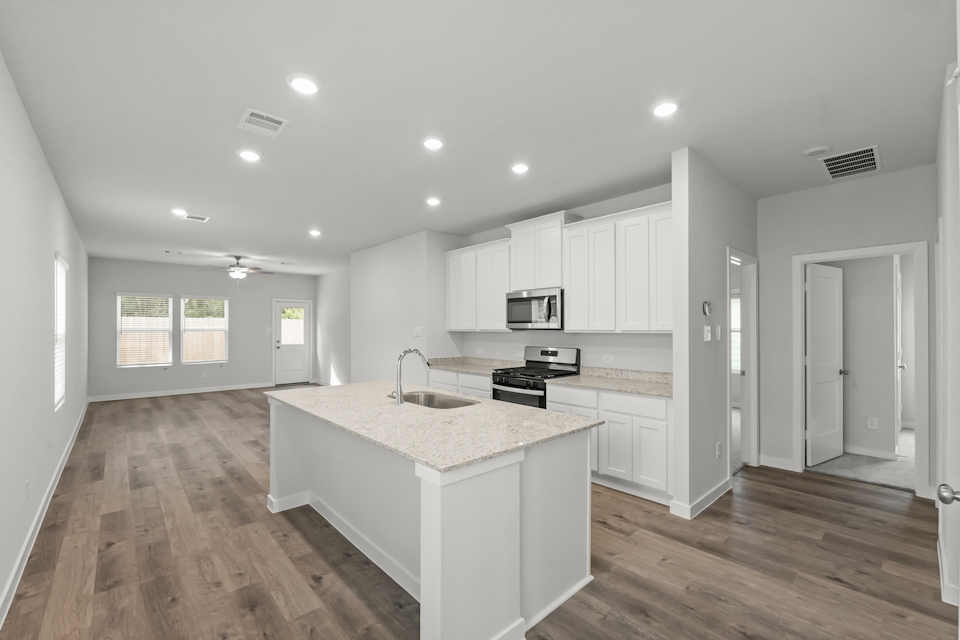 A kitchen with white cabinets.