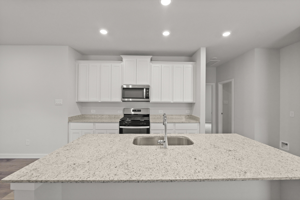A kitchen with white cabinets.