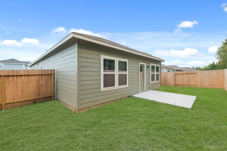A small house with a fence.