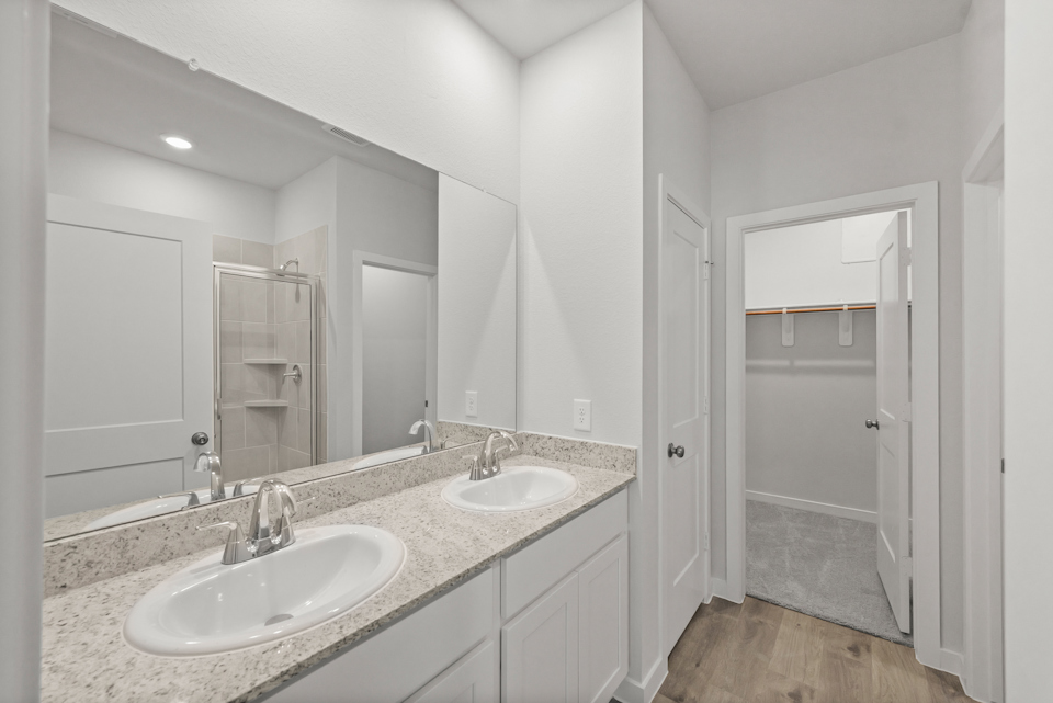 A bathroom with a large mirror.