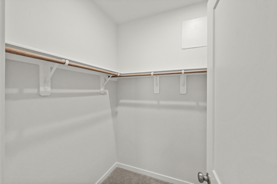 A white door with a metal bar.