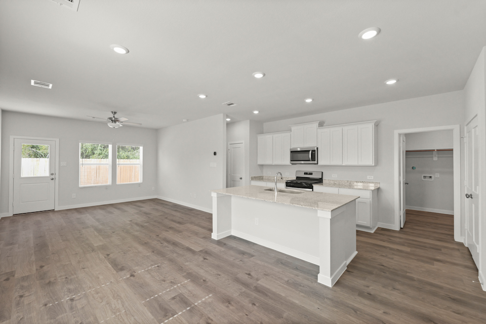 A kitchen with white cabinets.