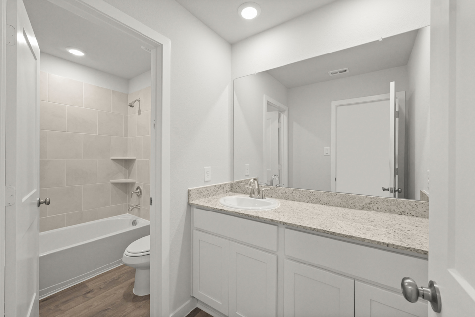 A bathroom with a marble countertop.
