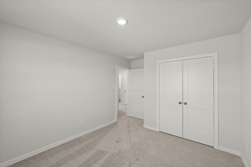 A hallway with white doors.