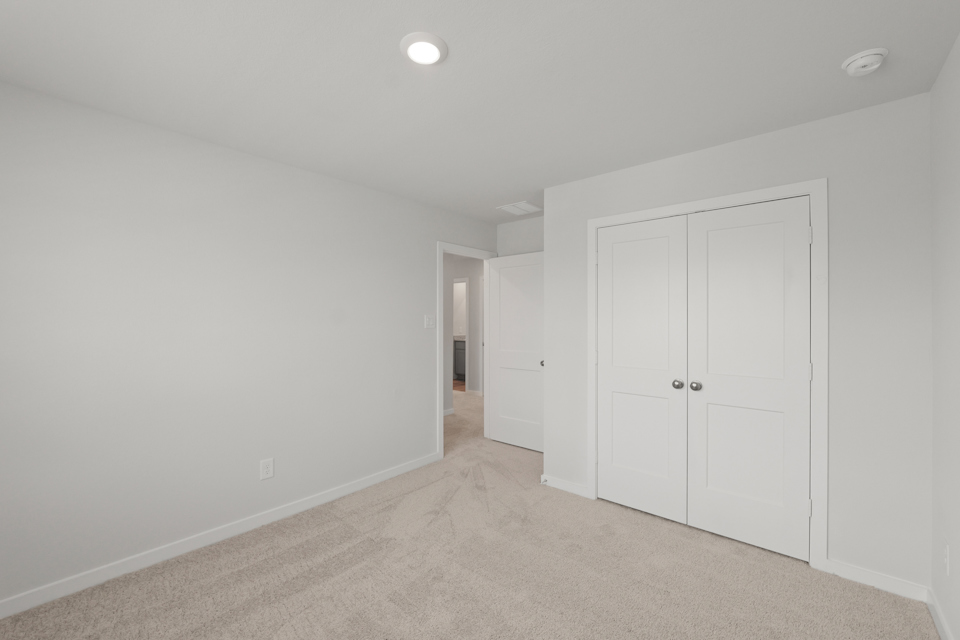 A hallway with white doors.
