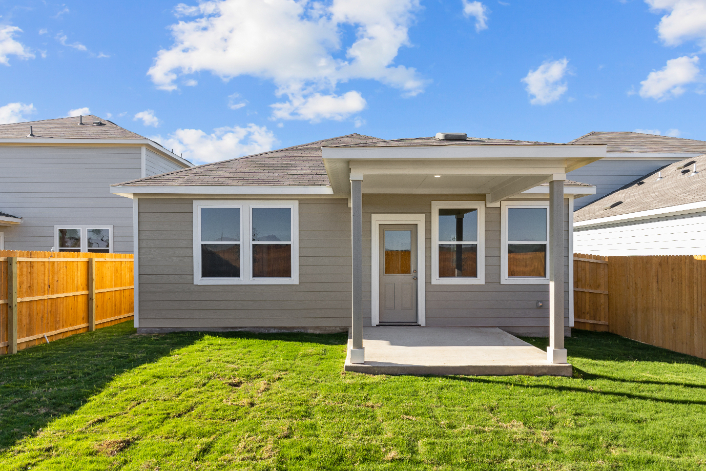 A house with a fence and grass.