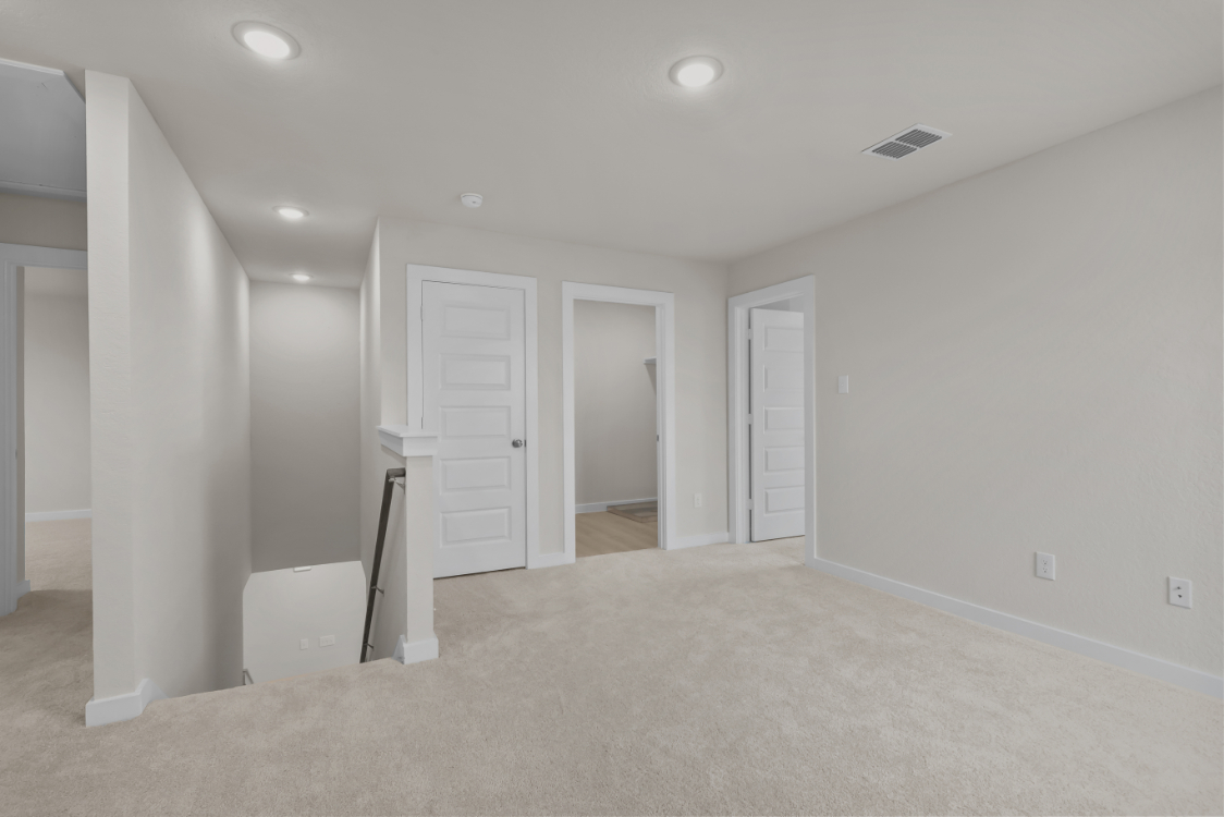 A hallway with white doors.