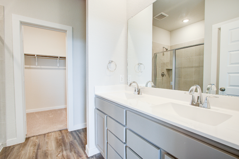 A bathroom with a large mirror.