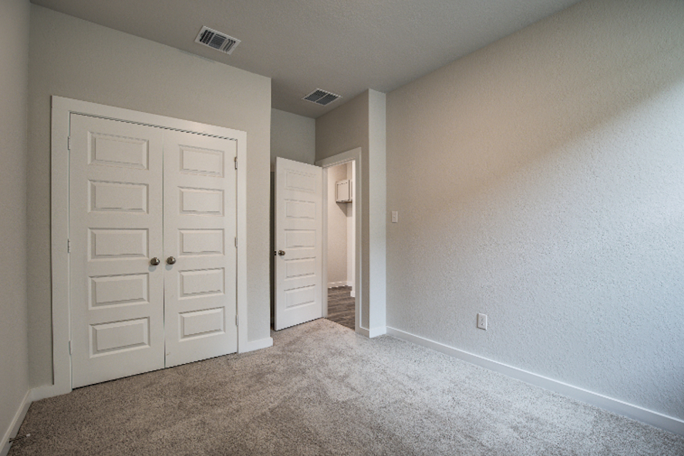 A hallway with white doors.