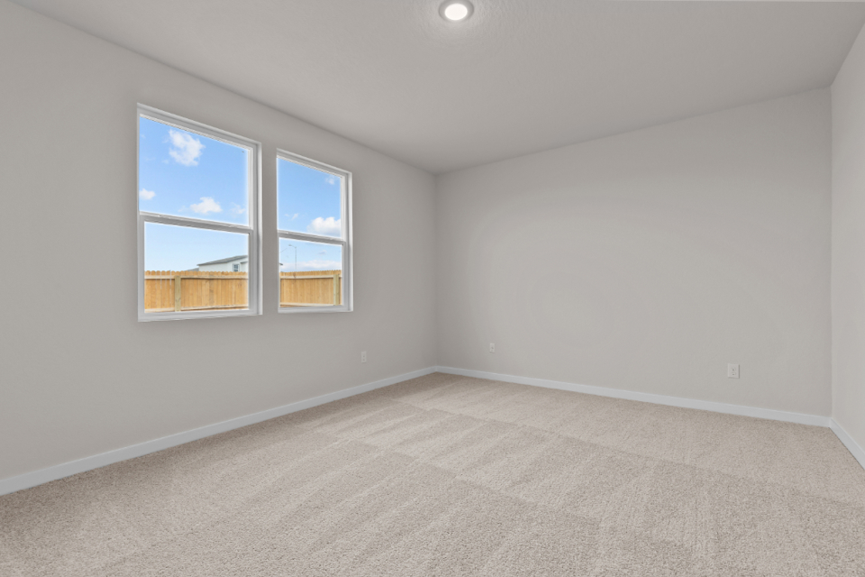 A room with a window and a carpet.