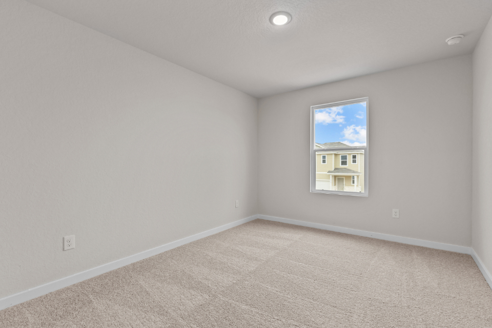 A room with a painting on the wall.
