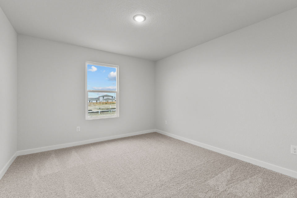 A white room with a painting on the wall.