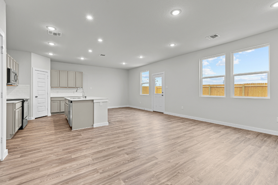 A kitchen with white cabinets.