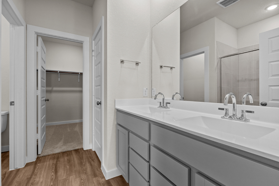 A bathroom with a large mirror.