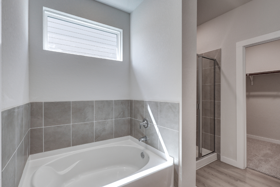 A bathroom with a tub and shower.