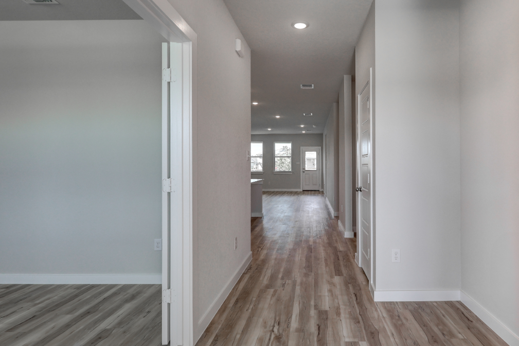 A long hallway with white walls.
