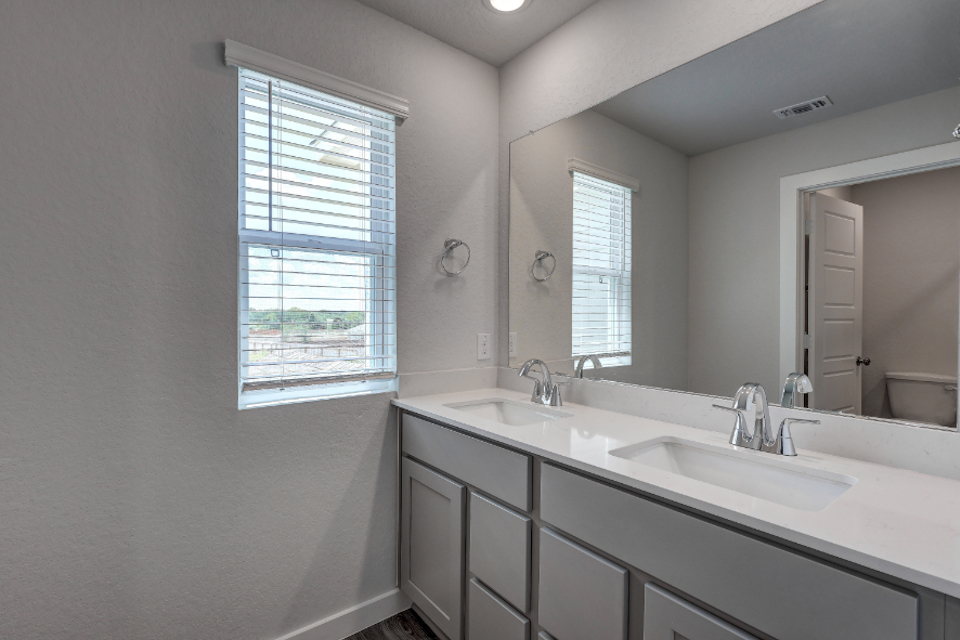 A bathroom with a large mirror.
