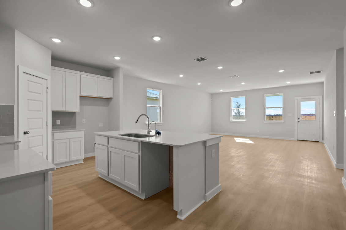 A kitchen with white cabinets.