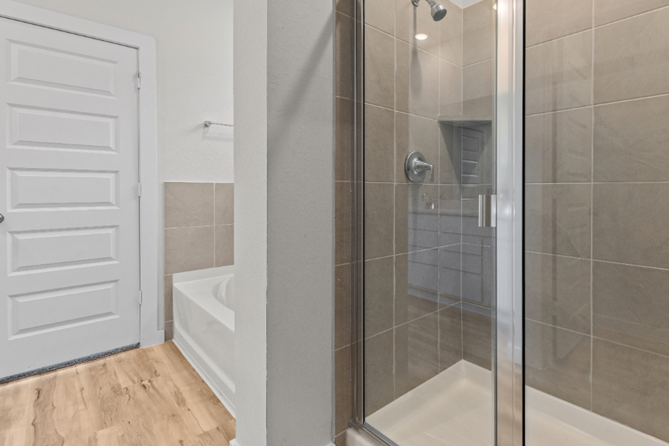 A shower with a glass door.