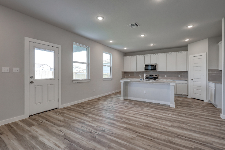 A kitchen with white cabinets.