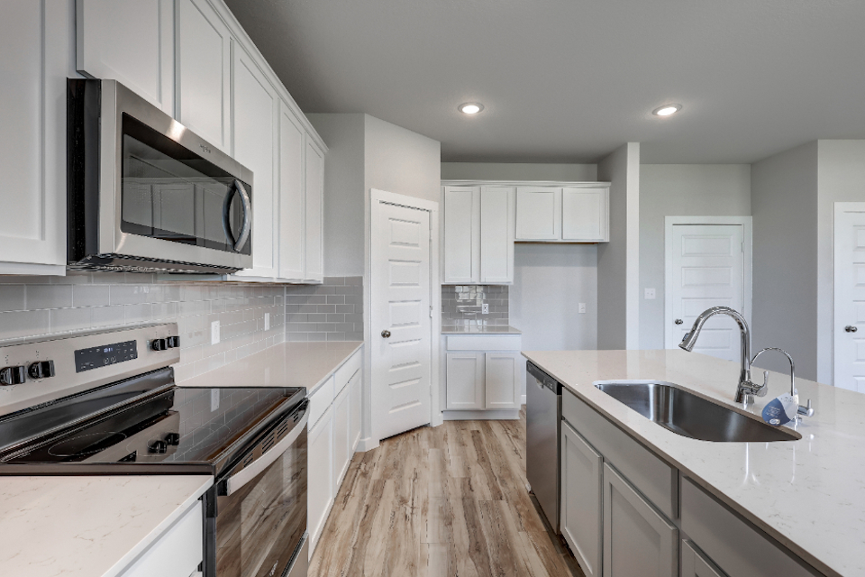 A kitchen with white cabinets.
