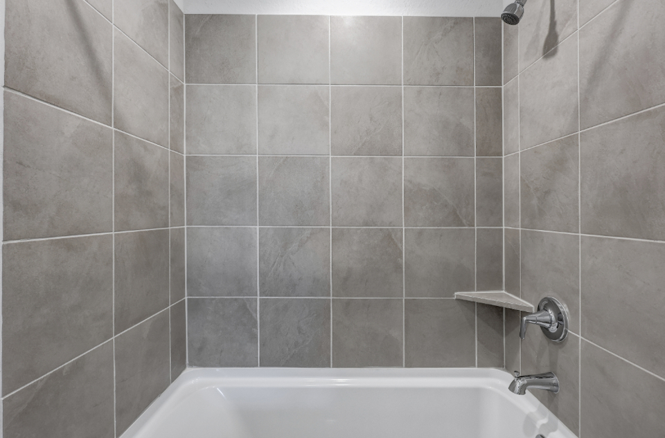 A bathtub and a sink in a bathroom.