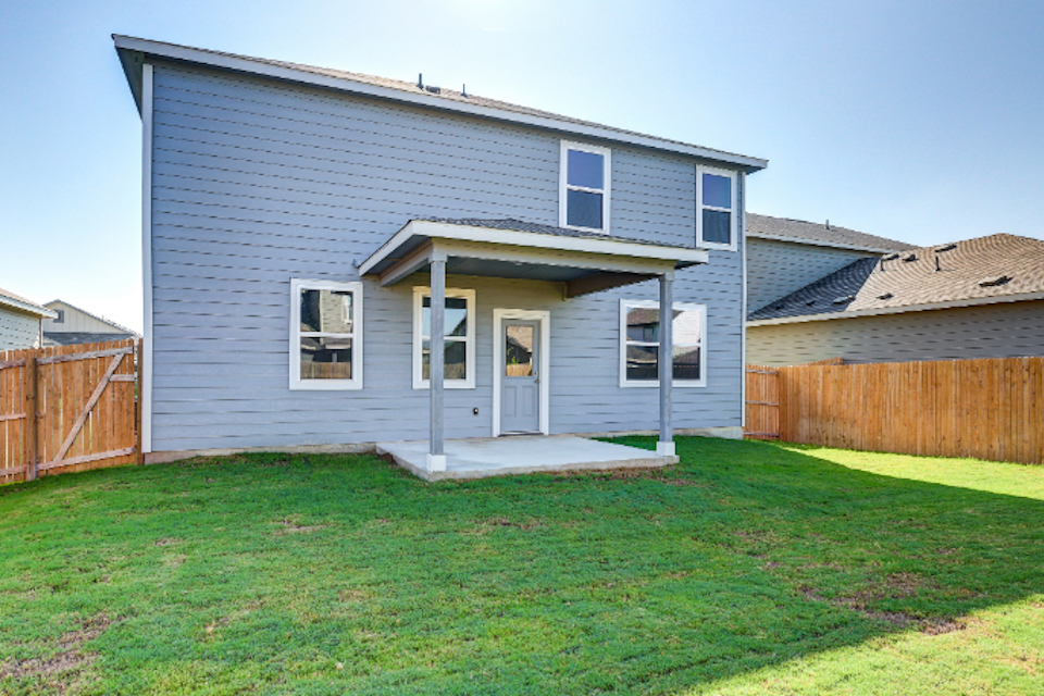 A house with a fence and grass.