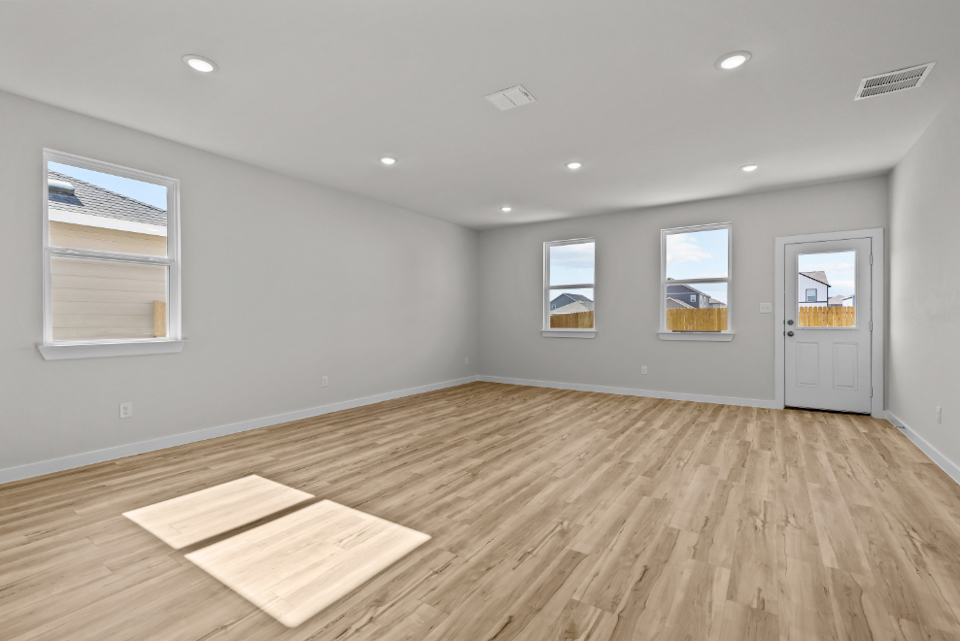 A room with a wood floor and a wood floor with a rug.