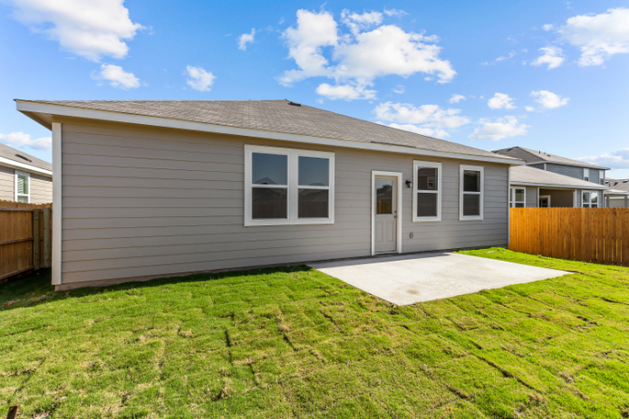 A house with a fence and grass.