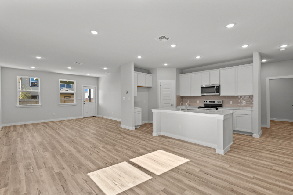 A large kitchen with white cabinets.
