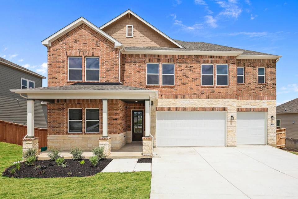 A brick house with a garage.