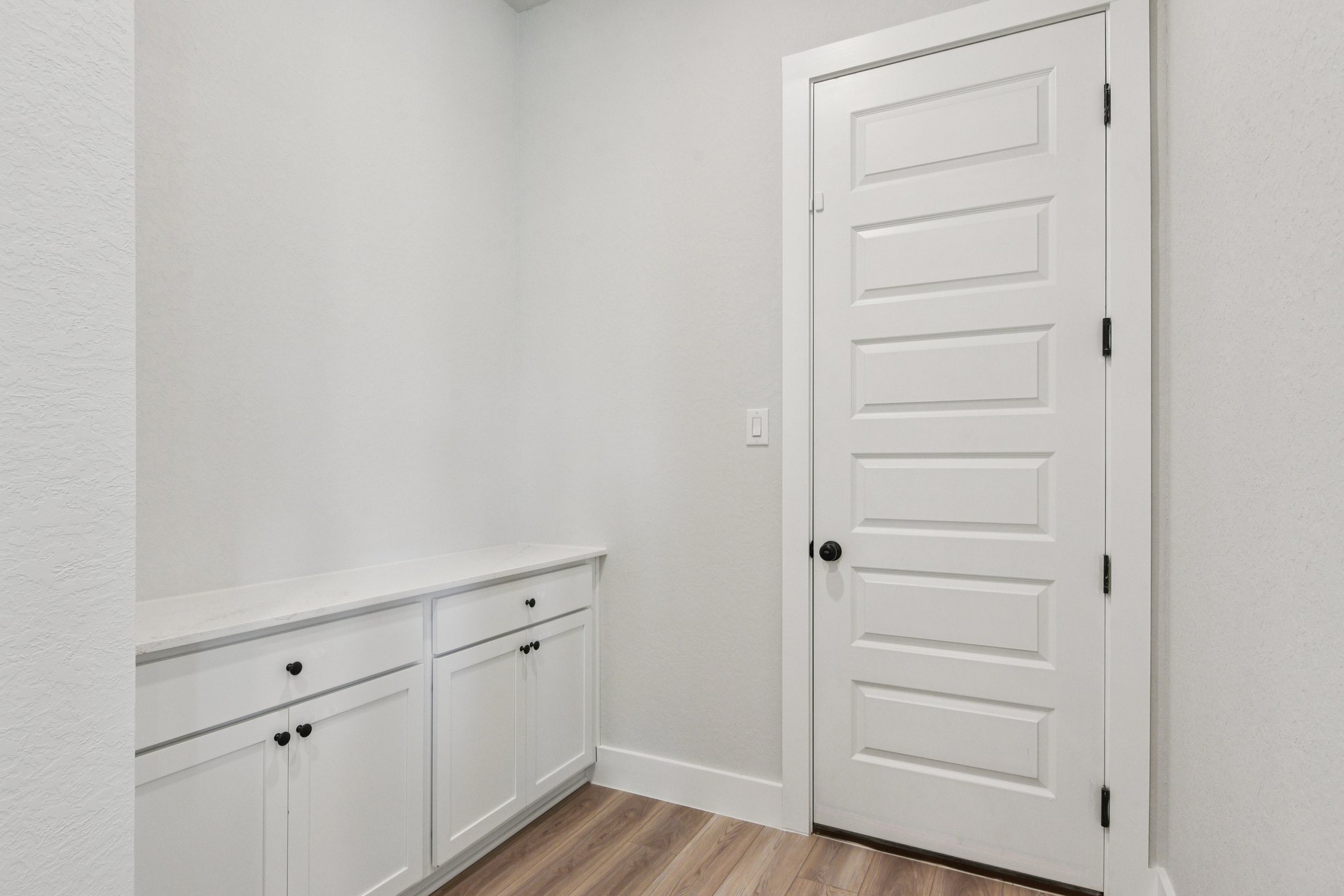 A white cabinet in a room.
