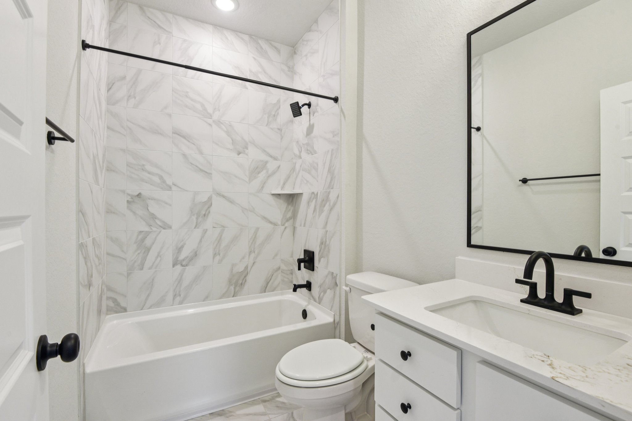A bathroom with a shower and toilet.