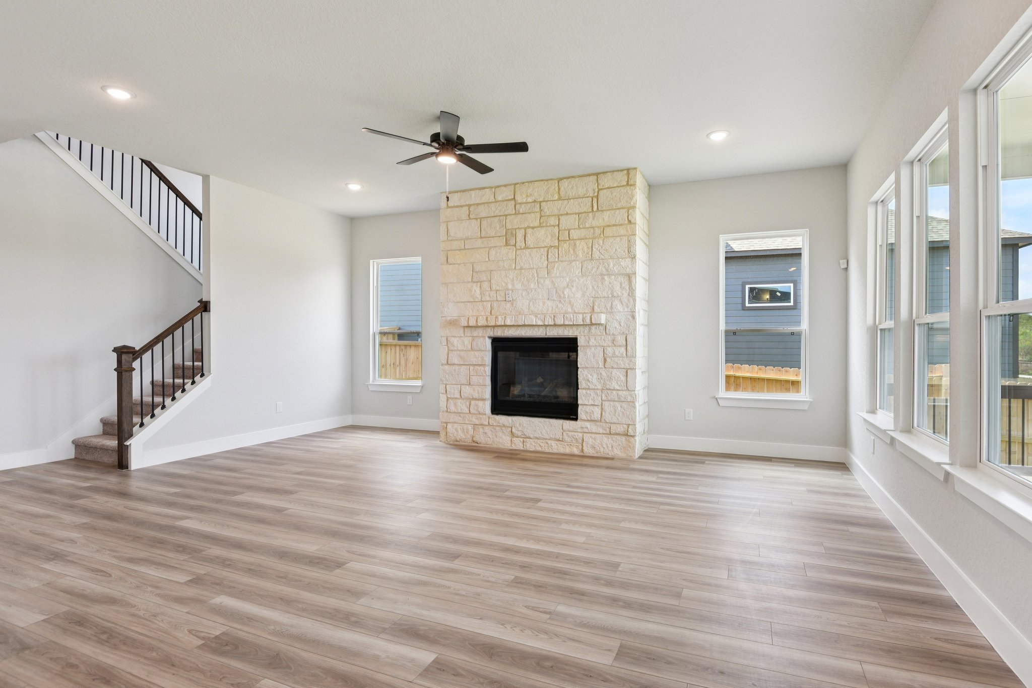 A room with a fireplace and a wood floor.