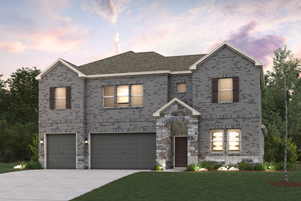 A large grey house with a driveway.
