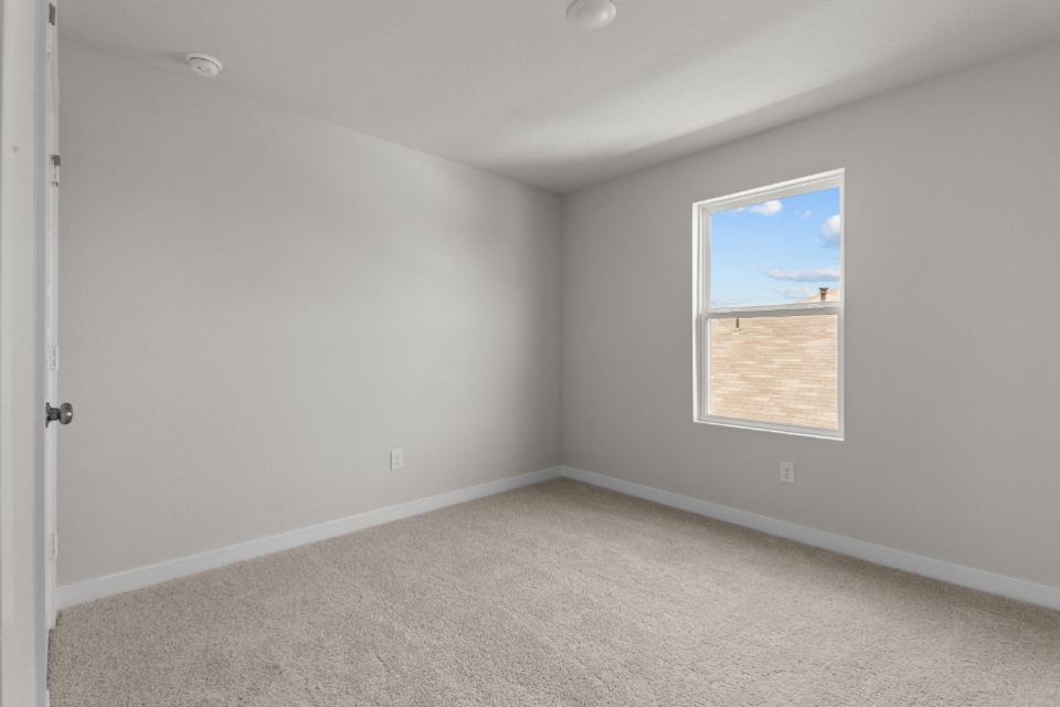 A room with a window and a door.