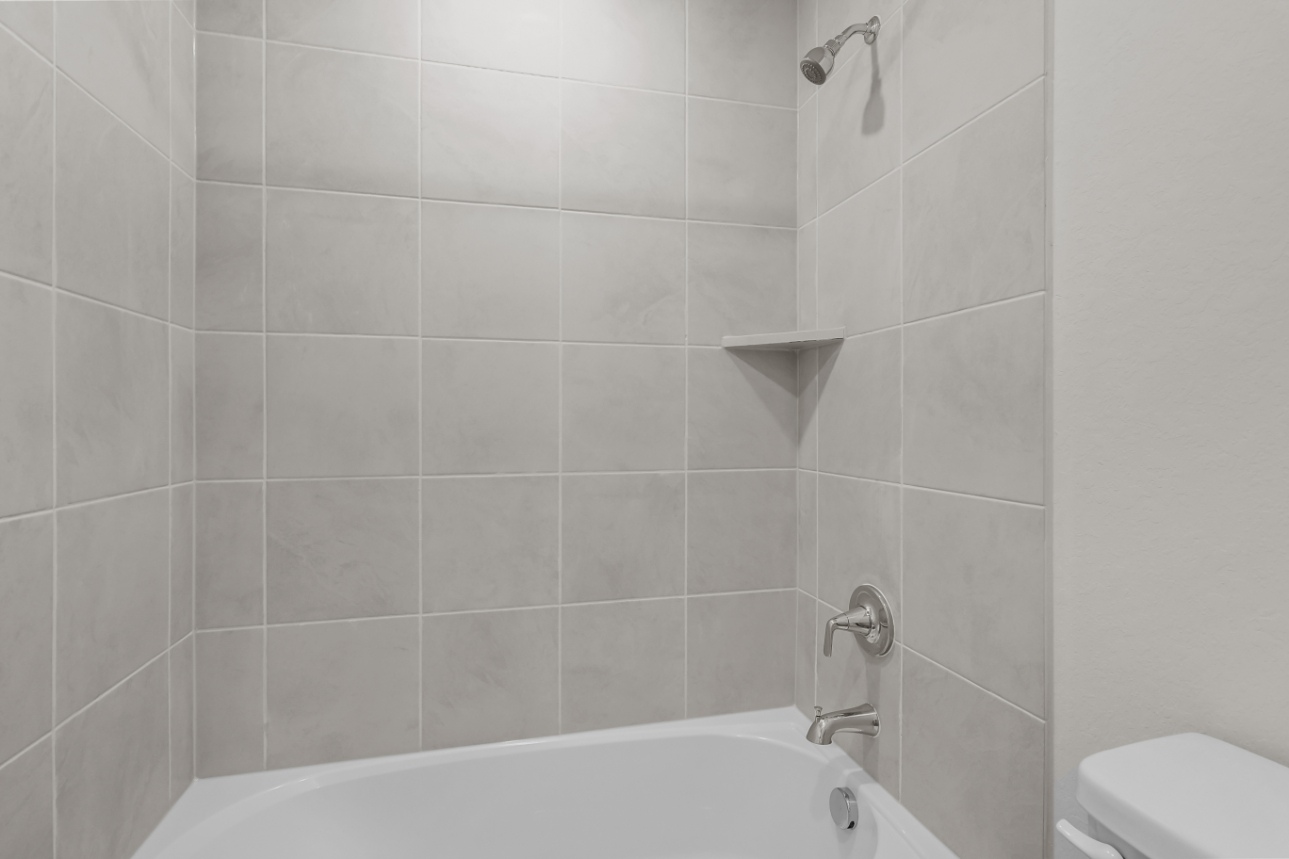 A bathtub in a bathroom.