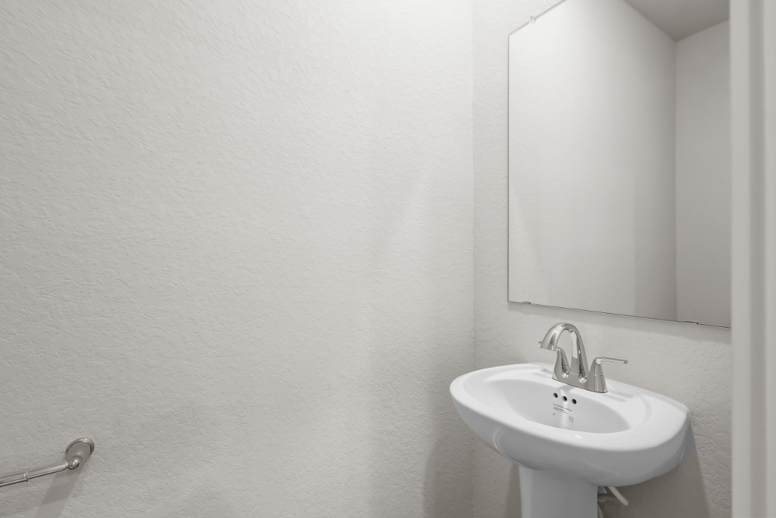 A bathroom with a mirror and sink.