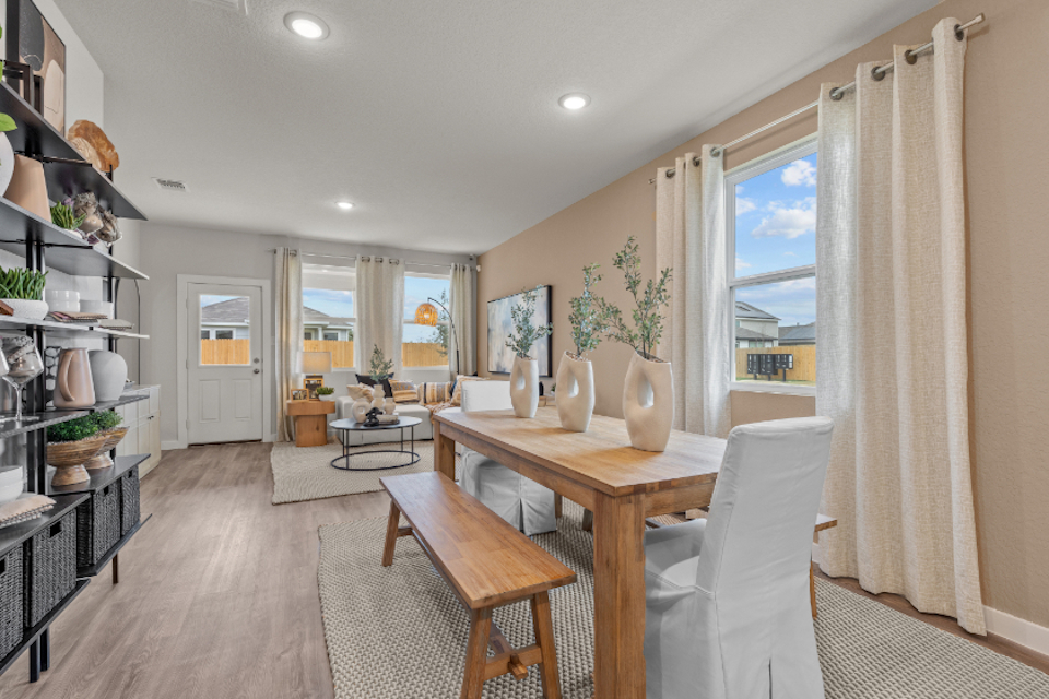 A dining room with a table and chairs.