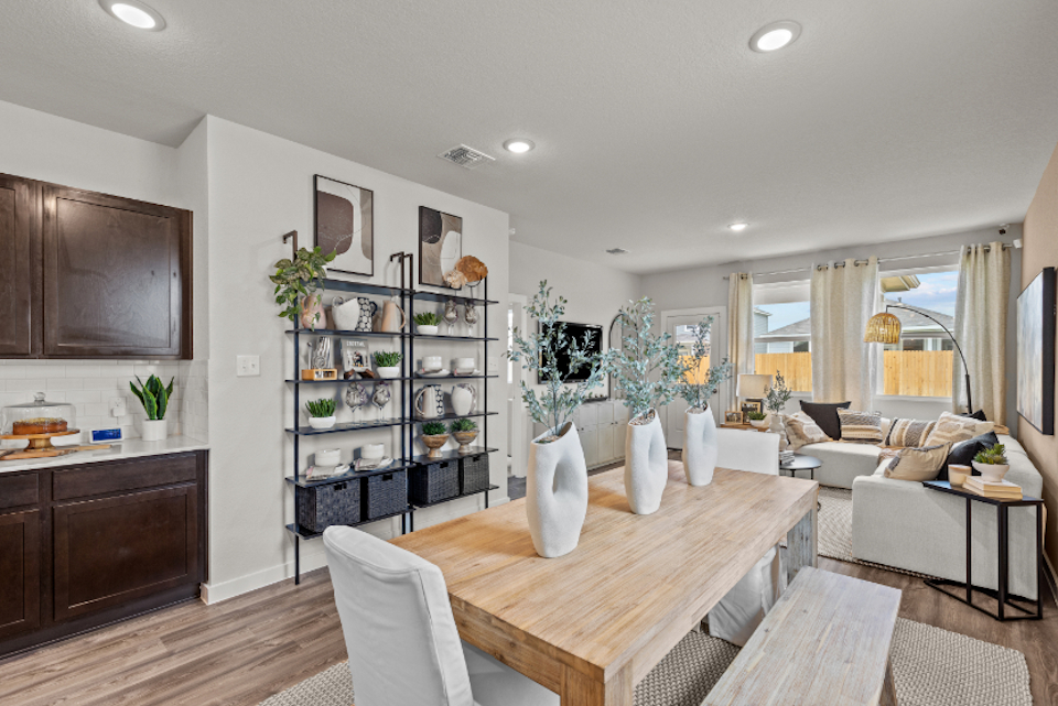 A living room with a table and chairs.
