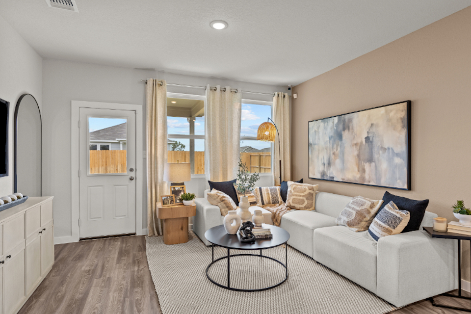 A living room with a white couch and a coffee table.