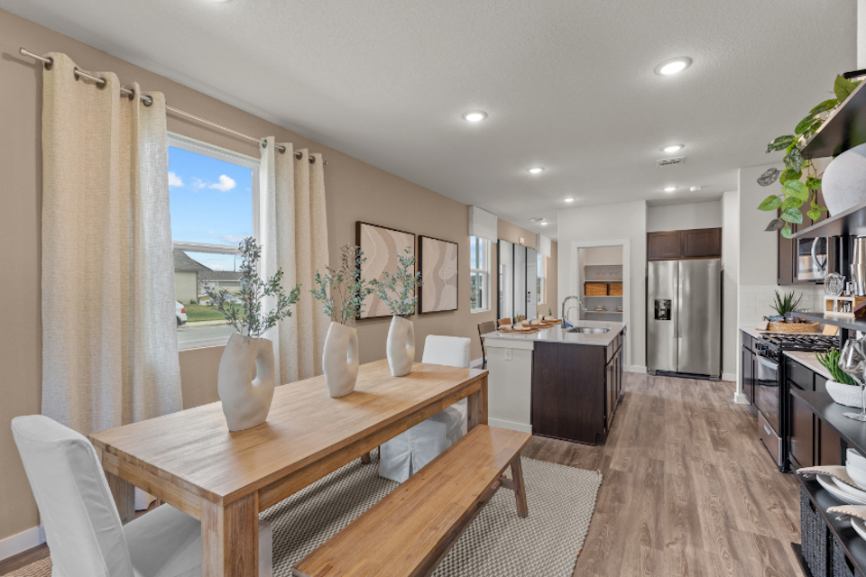 A kitchen with a dining table.